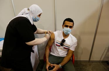 A Bahraini man gets a dose of a coronavirus disease (COVID-19) vaccine, at Bahrain International Exhibition & Convention Centre (BIECC), in Manama. (Reuters)