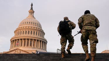 National Guard members walk at the Capitol, in Washington, US, January 15, 2021. (Reuters/Joshua Roberts)