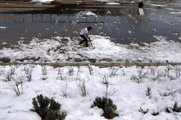 Members of a skating club clear ice and snow from the public area where they train after heavy snowfall in Madrid, Spain. (Reuters)