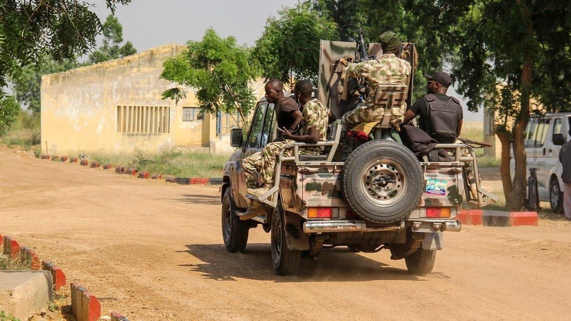 Nigerian Army soldiers are seen driving on a military vehicle in Ngamdu, Nigeria, on November 3, 2020. (Audu Marte/AFP)