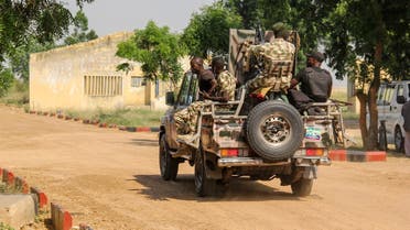 Nigerian Army soldiers are seen driving on a military vehicle in Ngamdu, Nigeria, on November 3, 2020. (Audu Marte/AFP)