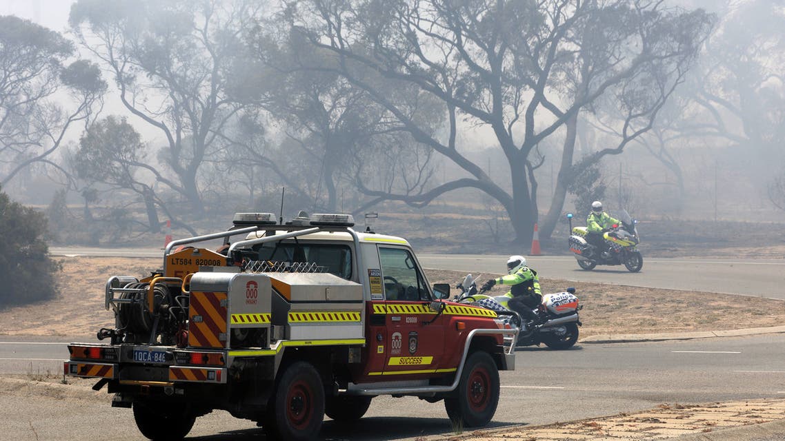 Emergency vehicles patrol the perimeter while battling a bush fire in Kwinana, some 30 kilometres south of Perth on January 4, 2021. TREVOR COLLENS / AFP