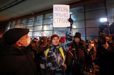 An activist holds a placard which reads: Love is stronger than fear, outside a terminal before the arrival of Russian opposition leader Alexei Navalny at Vnukovo International Airport in Moscow, Russia January 17, 2021. (Reuters/Shamil Zhumatov)