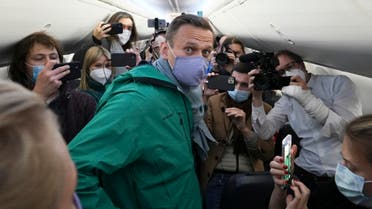  Alexei Navalny is surrounded by journalists inside the plane prior to his flight to Moscow in the Airport Berlin Brandenburg (BER) in Schoenefeld, near Berlin, Germany, Sunday, Jan. 17, 2021. Leading Kremlin critic Alexei Navalny plans to fly home to Russia on Sunday after recovering in Germany from his poisoning in August with a nerve agent. (AP Photo/Mstyslav Chernov)