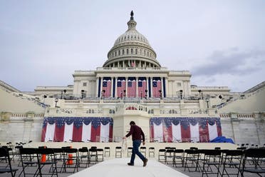 A worker pulls cables as preparations take place for President-elect Joe Biden's inauguration ceremony at the US Capitol in Washington. (AP)