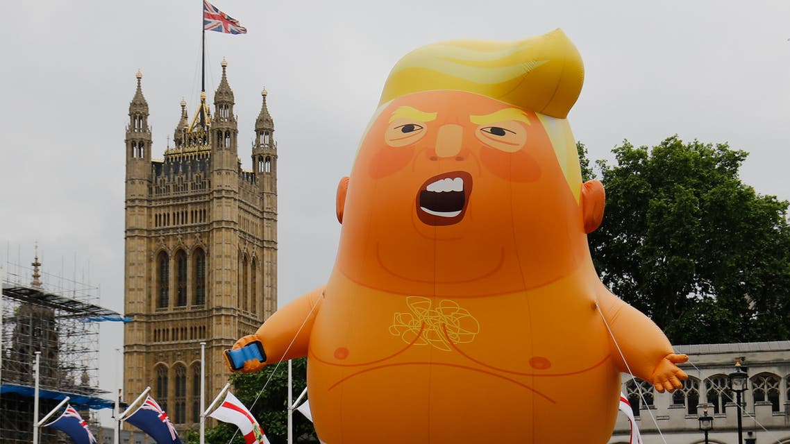 A giant balloon depicting US President Donald Trump as an orange baby floats above anti-Trump demonstrators in Parliament Square outside the Houses of Parliament in London on June 4, 2019, on the second day of Trump's three-day State Visit to the UK. (AFP)