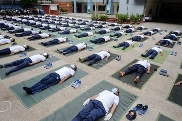 Members of the Bangladesh police attend a yoga session to boost the immune system of police personnel during the COVID-19 coronavirus pandemic, in Dhaka on June 8, 2020. (Munir Uzzaman/AFP)