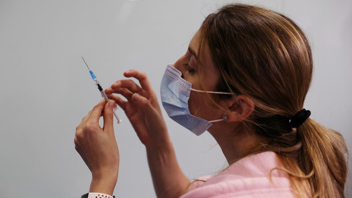 A medical worker prepares to administer a COVID-19 vaccine in Israel. (Reuters)