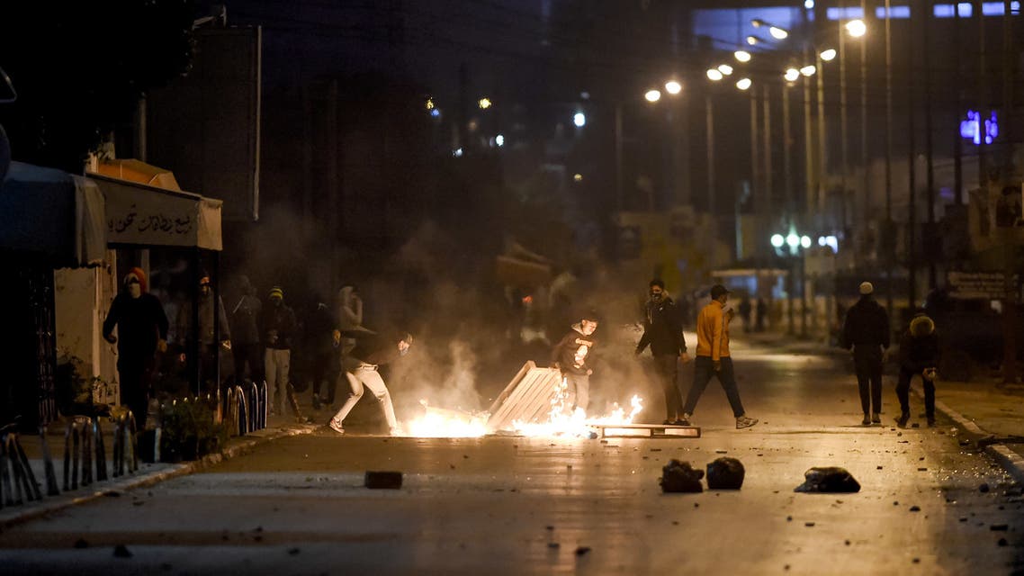 Protesters block a street during clashes with security forces in the Ettadhamen city suburb on the northwestwern outskirts of Tunisia's capital Tunis on January 17, 2021, amidst a wave of nightly protests in the North African country. (AFP)