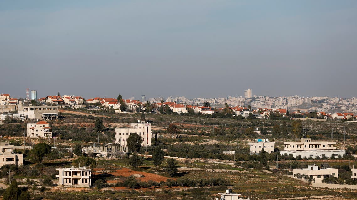 A view shows Palestinian houses as an Israeli settlement is seen in the background near Ramallah in the Israeli-occupied West Bank. (Reuters)