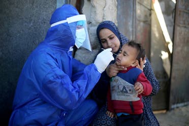 A Palestinian medical worker collects a swab sample from a boy to be tested for the coronavirus disease (COVID-19), in the southern Gaza Strip. (File photo: Reuters)