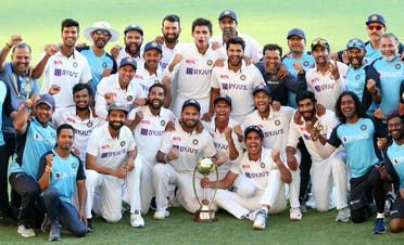 The Indian cricketers pose for a celebratory team photo  after winning on day five of the fourth test match between Australia and India at the Gabba in Brisbane, Australia, on January 19, 2021. (Reuters)
