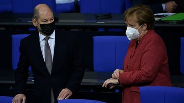 German Chancellor Angela Merkel and German Finance Minister and Vice-Chancellor Olaf Scholz arrive for a debate at the Bundestag in Berlin on December 9, 2020. (Tobias Schwarz/AFP)