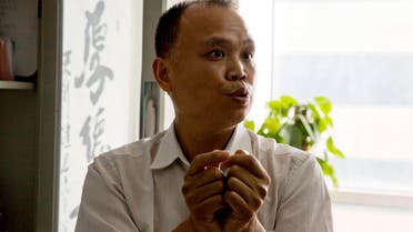  In this Thursday, July 23, 2015 photo, Chinese lawyer Yu Wensheng holds up his hands to show how death row prisoners are handcuffed 24 hours a day during an interview at his office in Beijing. Chinese lawyer who spoke up on behalf of rights lawyers persecuted by authorities was himself taken away by police in handcuffs, his wife said Friday, Aug. 7. (AP Photo/Ng Han Guan)