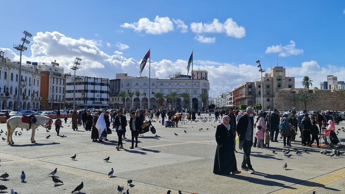 People walk by in Martyr's square in Libya's capital Tripoli, on January 19, 2021. (AFP)