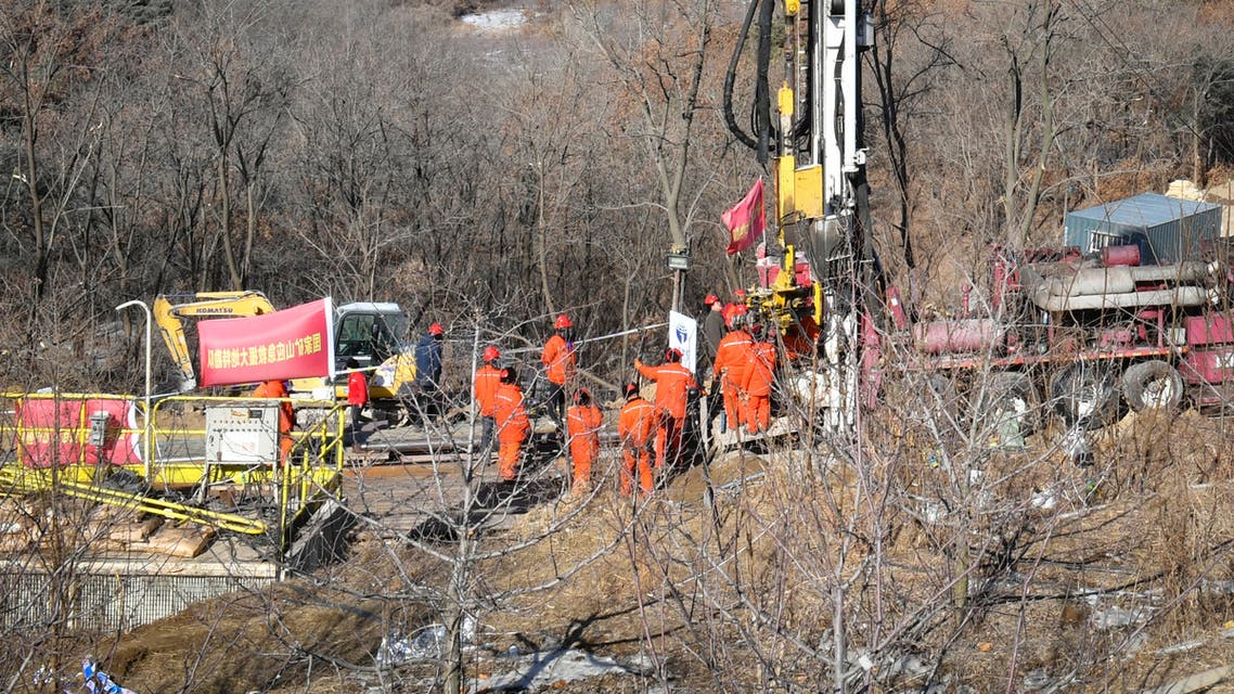 This photo taken on January 13, 2021 shows rescuers working at the site of gold mine explosion where 22 miners were trapped underground in Qixia, in eastern China's Shandong province. Miners trapped underground in eastern China for more than a week after a blast at a gold mine have managed to send up a note to rescuers, the local government said on January 18.