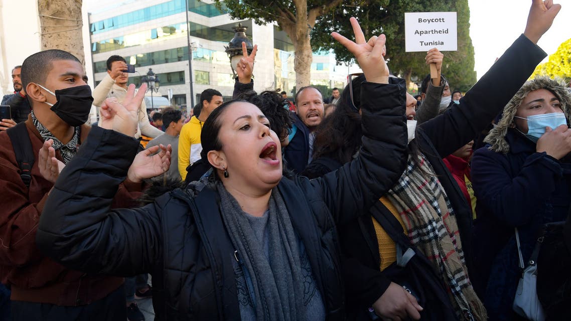 Tunisian protesters shout slogan during an anti-government demonstration on the Habib Bourguiba avenue in the capital Tunis, on January 20, 2021.