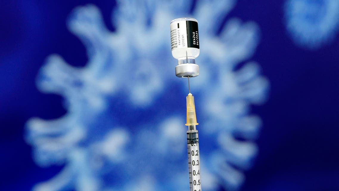 An Israeli health worker administers a dose of the Pfizer-BioNtech Covid-19 vaccine to a woman at Clalit Health Services, in the hallways of the Netanya stadium, on January 20, 2021 in the Israeli coastal city of Netanya. (AFP)