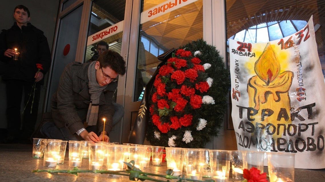 A man places a candle at a memorial inside the Moscow railway station in Saint Petersburg on January 25, 2011, the day after bomb attack at Moscow’s Domodedovo airport killed 35 people. (Kirill Kudryavtsev/AFP)