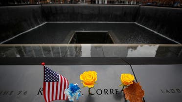 A flag and yellow rose are placed on an inscribed name of a veteran at the 9/11 Memorial during Veterans Day in New York. (Reuters)