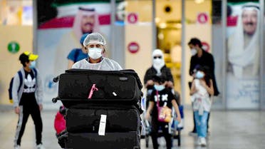 Kuwaiti nationals arrive at the Kuwait International Airport, May 3, 2020 during the novel coronavirus pandemic crisis. (Yasser aL-Zayyat/AFP)