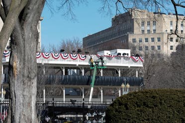 Workers make adjustments to the inaugural parade viewing stand across the front of The White House, ahead of U.S. President-elect Joe Biden's inauguration, in Washington. (reuters)