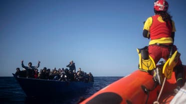 Migrants from Eritrea, Egypt, Syria and Sudan, are assisted by aid workers of the Spanish NGO Open Arms, after fleeing Libya on board a precarious wooden boat in the Mediterranean sea, about 110 miles north of Libya, on Jan. 2, 2021. (AP)
