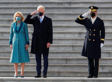 US President Joe Biden salutes next to first lady Jill Biden during the pass in review after the inauguration ceremony, in Washington, Jan. 20, 2021. (Reuters)