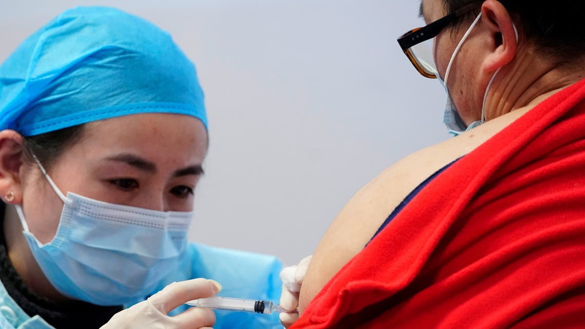A medical worker prepares to administer a dose of a coronavirus disease (COVID-19) vaccine to a man at a vaccination site, during a government-organised visit, following the coronavirus disease (COVID-19) outbreak, in Shanghai, China January 19, 2021. REUTERS/Aly Song
