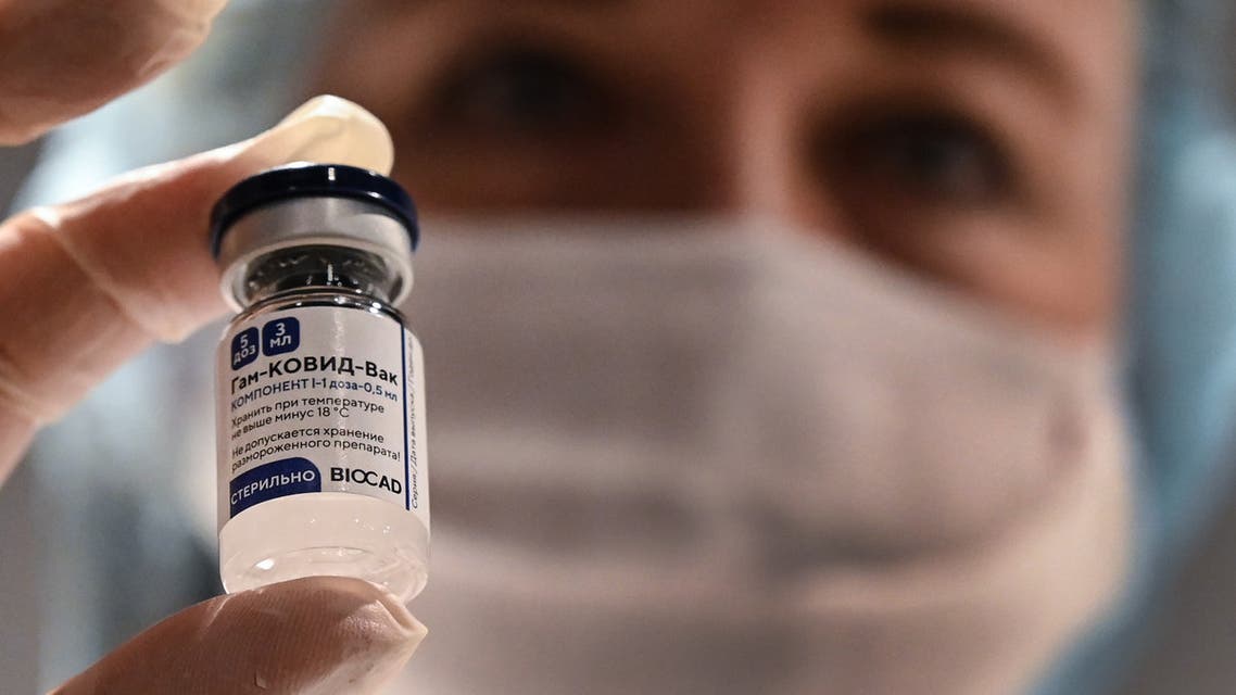 A medical worker holds a vial with Russia's Sputnik V (Gam-COVID-Vac) vaccine against the coronavirus disease at a vaccination point at the GUM department store in Moscow on January 18, 2021. (AFP)