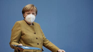 German Chancellor Angela Merkel arrives wearing a protective mask for a press conference on the current situation in Berlin, Germany, Thursday, Jan. 21, 2021.(AP)
