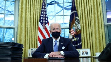 US President Joe Biden signs executive orders in the Oval Office of the White House in Washington, January 20, 2021. (Reuters)