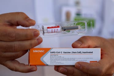 Dr. Gustavo Romero, of University Hospital of Brasilia’s Nucleus of Tropical Medicine, presents to the press China’s Sinovac Biotech experimental vaccine for the new coronavirus before it is administered to volunteers. (AP)