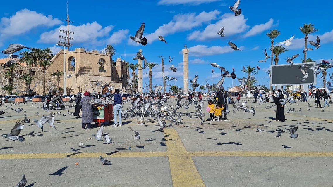 People watch pigeons in Martyr's square in Libya's capital Tripoli, on January 19, 2021. (AFP) 
