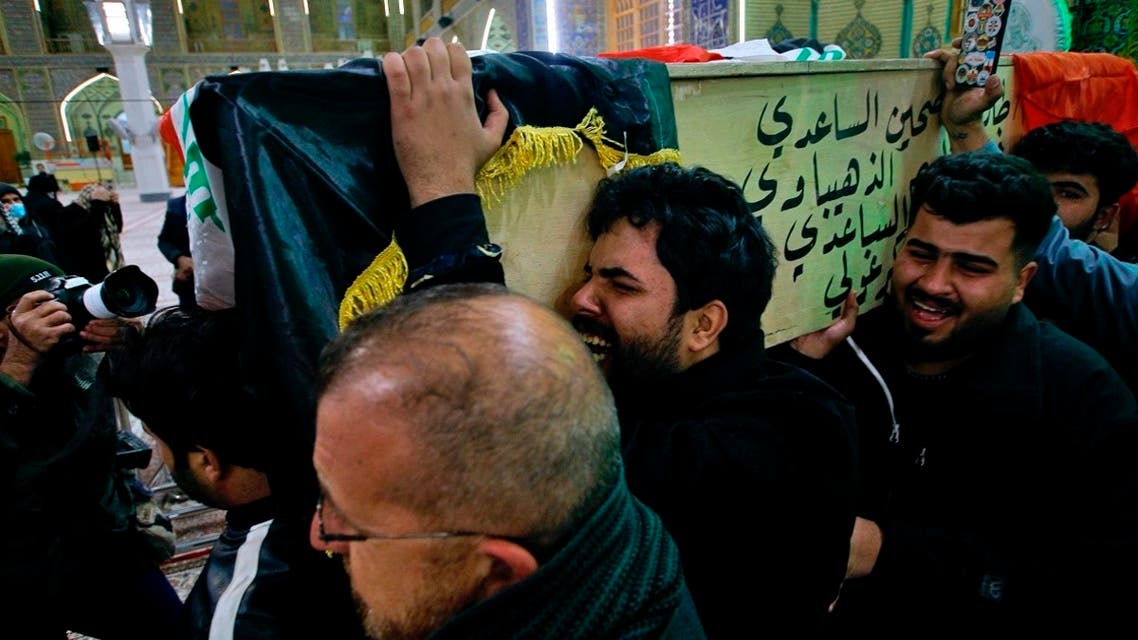 Mourners carry a flag-draped coffin of a suicide bomb victim, Ahmed Reda, during his funeral procession at the Imam Ali shrine in Najaf, Iraq, Jan. 21, 2021. (AP)