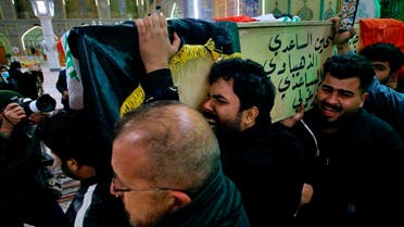Mourners carry a flag-draped coffin of a suicide bomb victim, Ahmed Reda, during his funeral procession at the Imam Ali shrine in Najaf, Iraq, Jan. 21, 2021. (AP) 