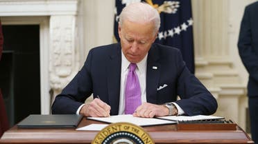 US President Joe Biden signs executive orders as part of the Covid-19 response in the State Dining Room of the White House, Jan. 21, 2021. (AFP)