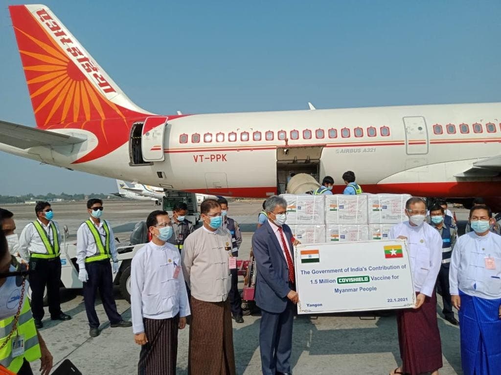 Officials stand in front of the plane as Myanmar receives the first batch of the coronavirus disease (COVID-19) vaccines from India at Yangon Airport in Yangon, Myanmar, on January 22, 2021. (Reuters)