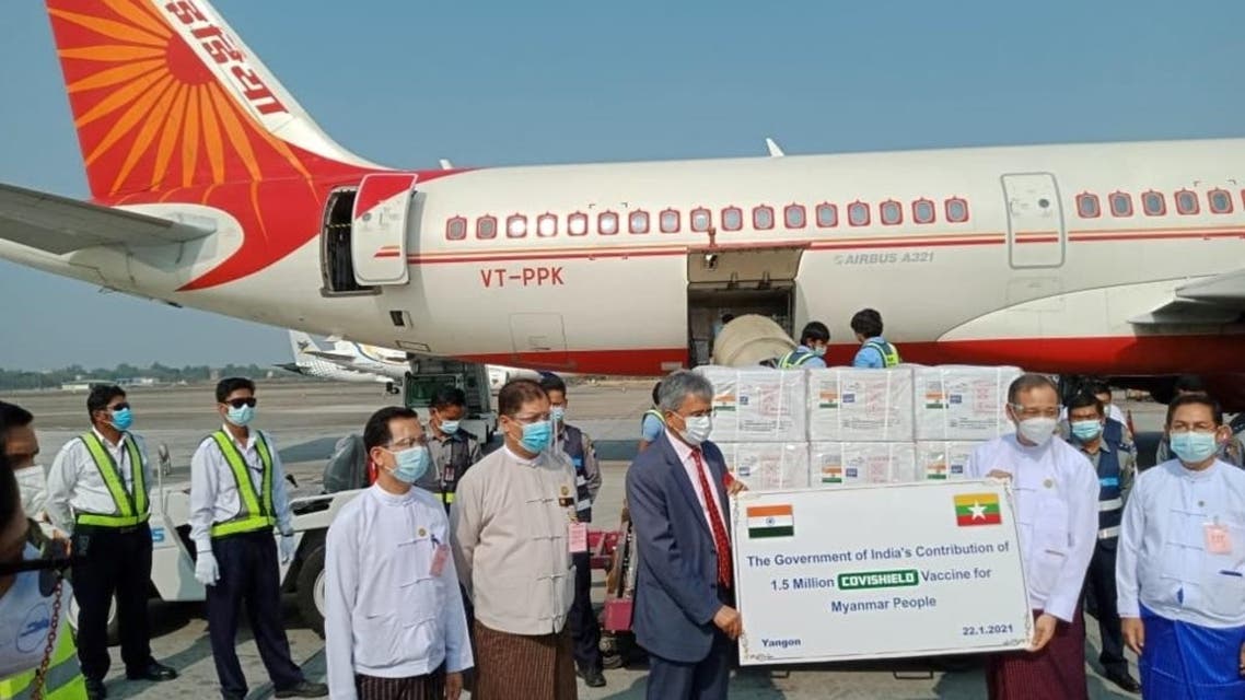 Officials stand in front of the plane as Myanmar receives the first batch of the coronavirus disease (COVID-19) vaccines from India at Yangon Airport in Yangon, Myanmar January 22, 2021. (Reuters)