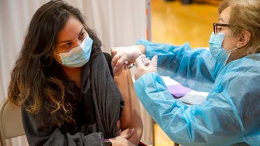 A person receives the Moderna COVID-19 vaccine in the gymnasium of International High School in Paterson, N.J., Jan. 20, 2021. (AP)