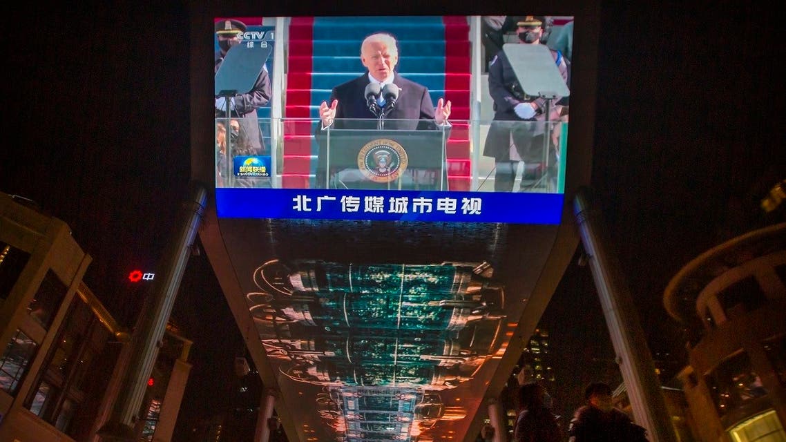 A large video shows a government news report about the inauguration of President Joe Biden at a shopping mall in Beijing, Jan. 21, 2021. (AP)