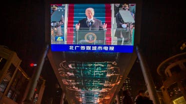 A large video shows a government news report about the inauguration of President Joe Biden at a shopping mall in Beijing, Jan. 21, 2021. (AP)