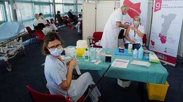 In this file photo taken on January 8, 2021 a medical staff receives the Pfizer-BioNTech Covid-19 vaccine at the Emile Muller hospital in Mulhouse, eastern France. (Sebastien Bozon/AFP)
