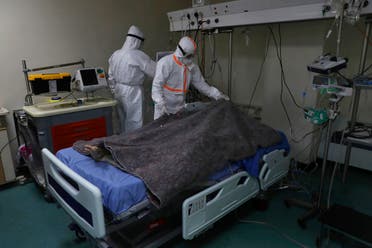 A medical staff covers with a blanket the body of a 35-year-old woman infected with COVID-19, at the intensive care unit of the Rafik Hariri University Hospital in Beirut, Lebanon. (AP)