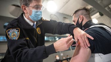 A member of the NYPD receives a dose of the Moderna vaccine in the Queens borough of New York, Jan. 11, 2021. (Reuters)