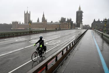 A cyclist rides across the deserted Westminster Bridge, amidst the current lockdown restrictions, as the spread of the coronavirus disease (COVID-19) continues, in London, Britain. (Reuters)