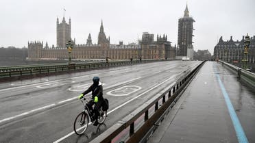 A cyclist rides across the deserted Westminster Bridge, amidst the current lockdown restrictions, as the spread of the coronavirus disease (COVID-19) continues, in London, Britain. (Reuters)