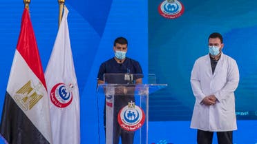 Nurse Ahmed Hamdan Zayed, left, and Dr. Abdel Menoim Selim, the first two Egyptians to receive the Sinopharm China-made COVID-19 vaccine, stand on a stage to answer questions during a press conference, at the Abu Khalifa Hospital in Ismailia, 120 km (75 miles) east of Cairo, Egypt, Sunday, Jan. 24, 2021. (AP)