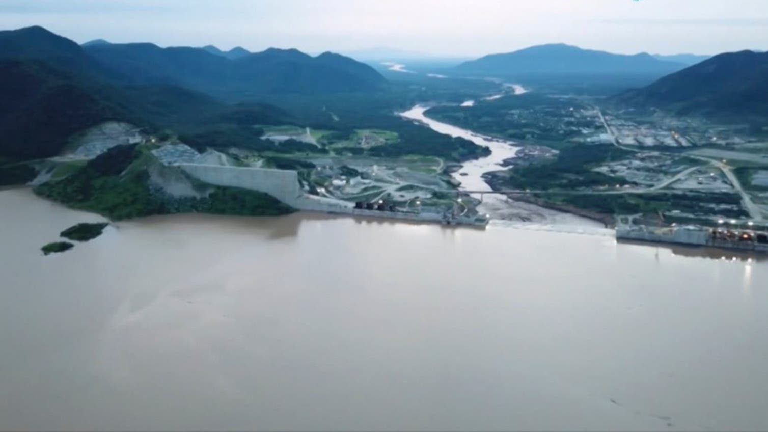 This frame grab from a video obtained from the Ethiopian Public Broadcaster (EBC) on July 20 and July 21, 2020 and released on July 24, 2020 shows water pouring out of the Renaissance Dam in Guba, Ethiopia, as Prime Minister Abiy Ahmed hails the historic early filling of the reservoir on the Blue Nile River that has stoked tensions with downstream neighbours Egypt and Sudan. (AFP)