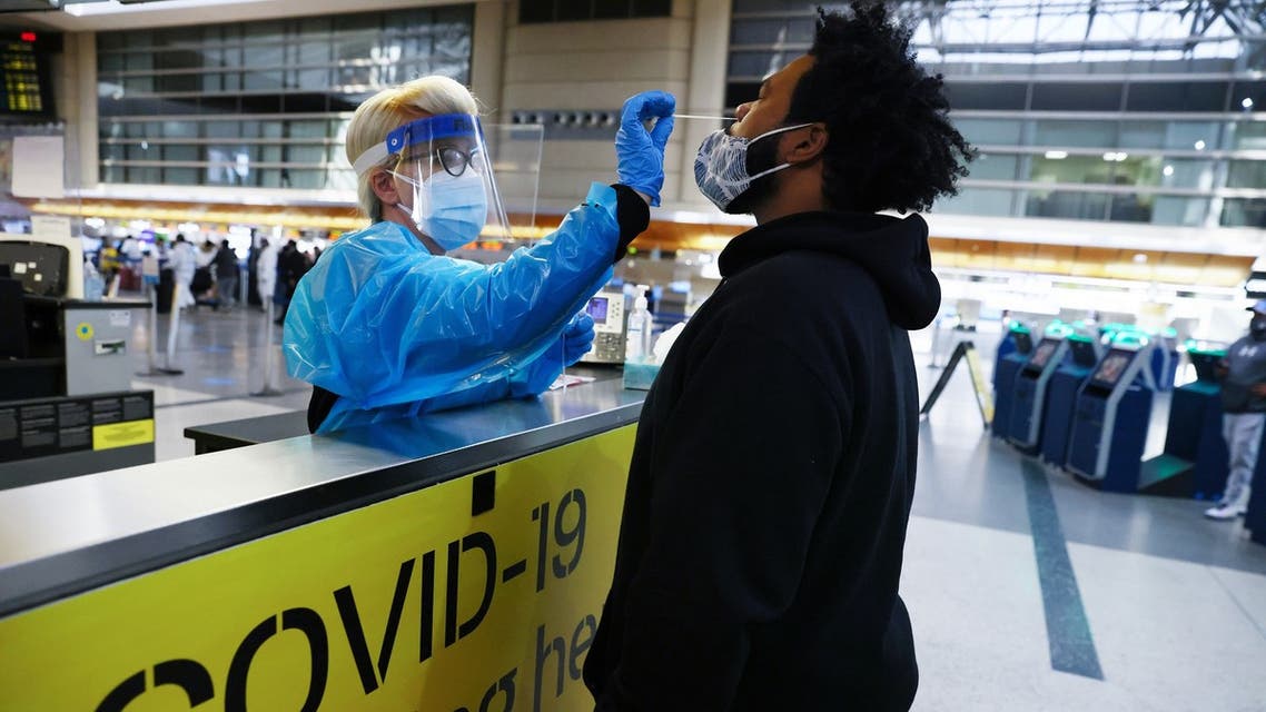 LOS ANGELES, CALIFORNIA - DECEMBER 22: A man receives a nasal swab COVID-19 test at Tom Bradley International Terminal at Los Angeles International Airport (LAX) amid a coronavirus surge in Southern California on December 22, 2020 in Los Angeles, California. The tests are not mandatory with results returned within 24 hours to help travelers avoid quarantining at their destinations. TSA agents screened over 1 million people for three consecutive days last Friday, Saturday and Sunday, the beginning of the traditional holiday travel season, for the first time since the start of the coronavirus pandemic. Mario Tama/Getty Images/AFP 